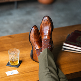 The Pecan Gemstones men's dress sock — pecan brown sock with navy, white & powder blue gemstones styled with olive trousers