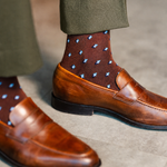 The Pecan Gemstones men's dress sock — pecan brown sock with navy, white & powder blue gemstones styled with olive trousers