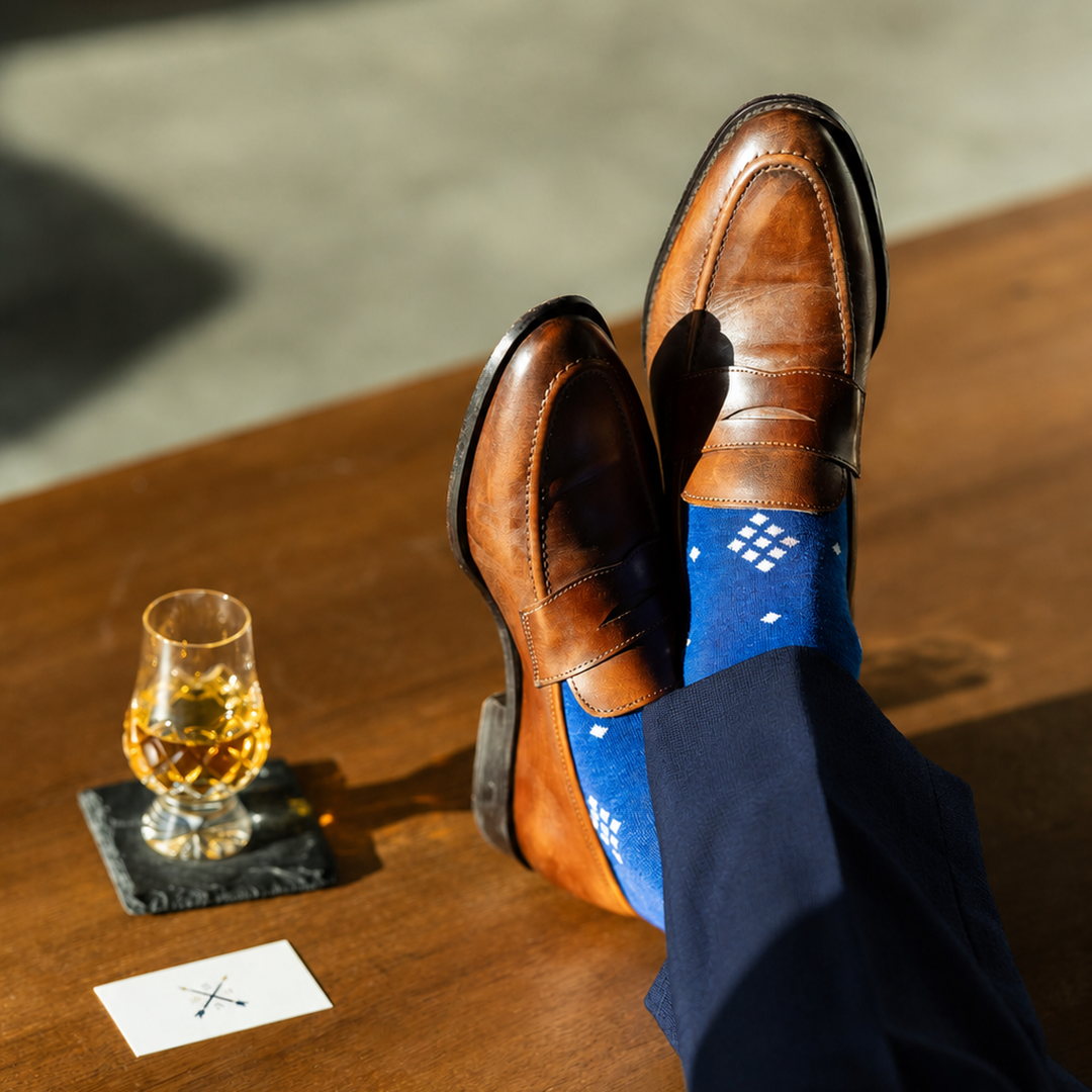 The Royal Blue Nested Diamonds men's dress sock — royal blue sock with white nested diamonds styled with navy trousers