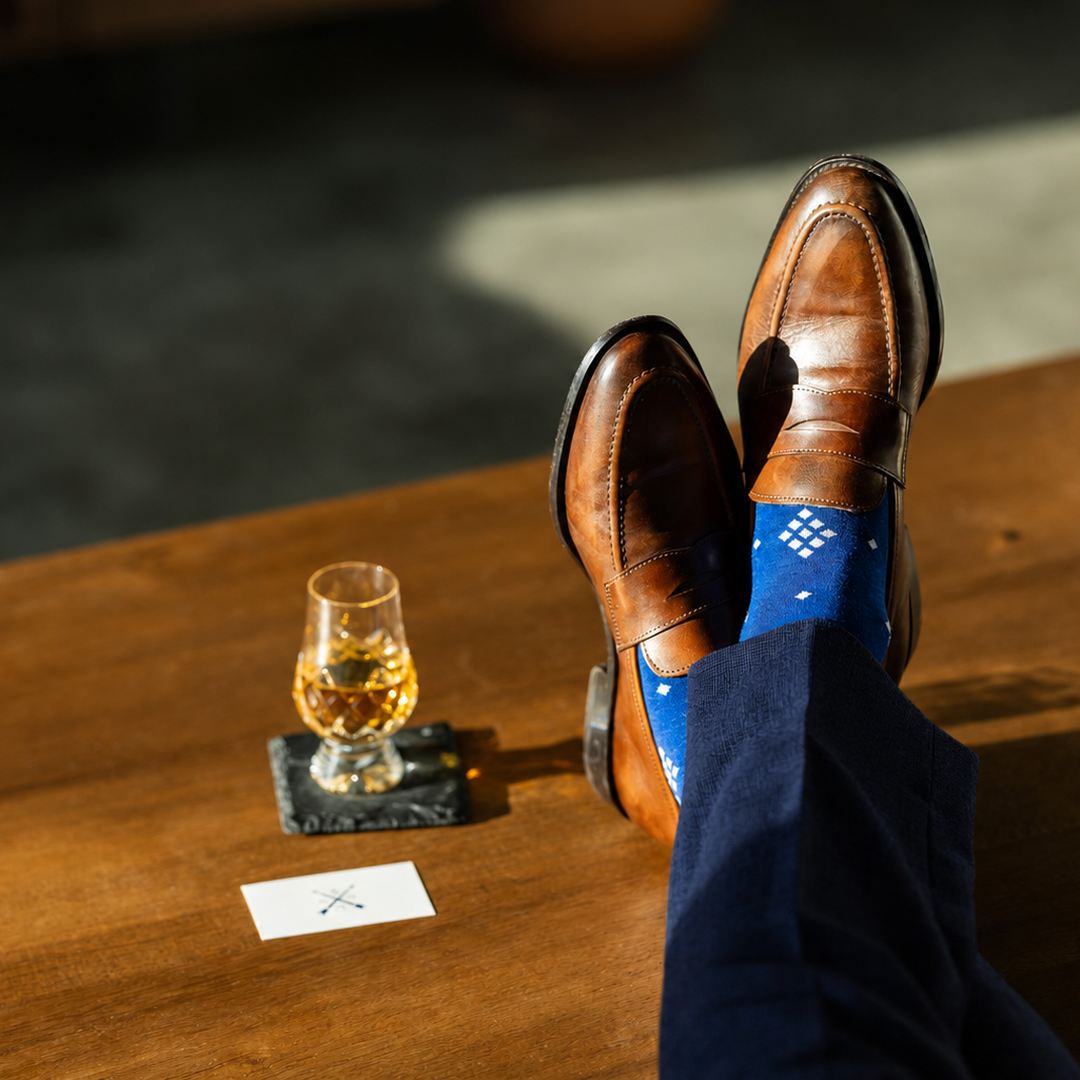 The Royal Blue Nested Diamonds men's dress sock — royal blue sock with white nested diamonds styled with navy trousers