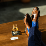 The Royal Blue Nested Diamonds men's dress sock — royal blue sock with white nested diamonds styled with navy trousers