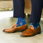 The Royal Blue Nested Diamonds men's dress sock — royal blue sock with white nested diamonds styled with navy trousers