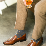 The Sage Gemstones men's dress sock — sage green sock with burnt orange, white & taupe gemstones styled with tan trousers