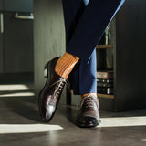 A mandarin orange men's dress sock with a navy ribbed pattern