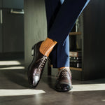 A mandarin orange men's dress sock with a navy ribbed pattern