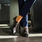 A mandarin orange men's dress sock with a navy ribbed pattern