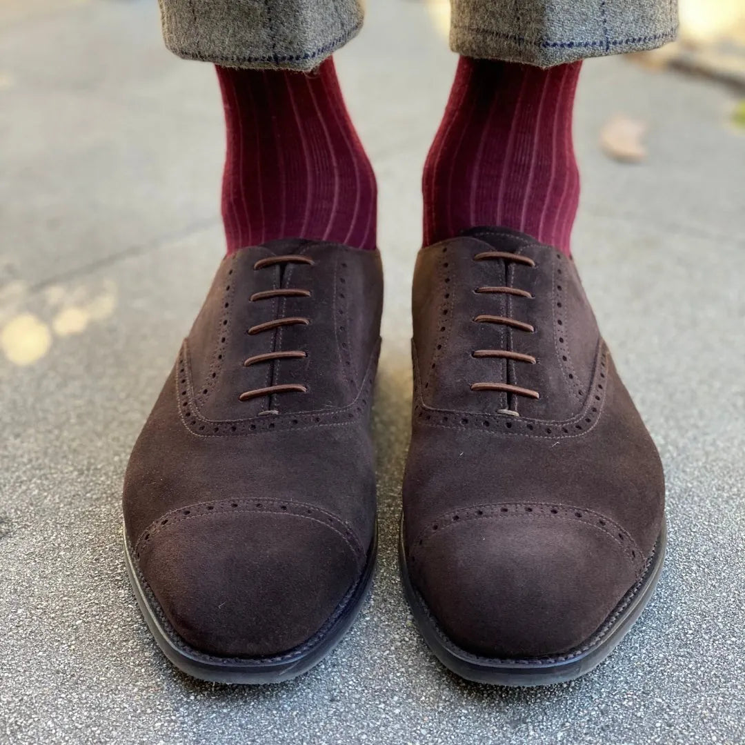 Man wearing solid, merlot ribbed men's socks with dress shoes.