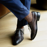 A mocha mousse sock with navy T-Suns