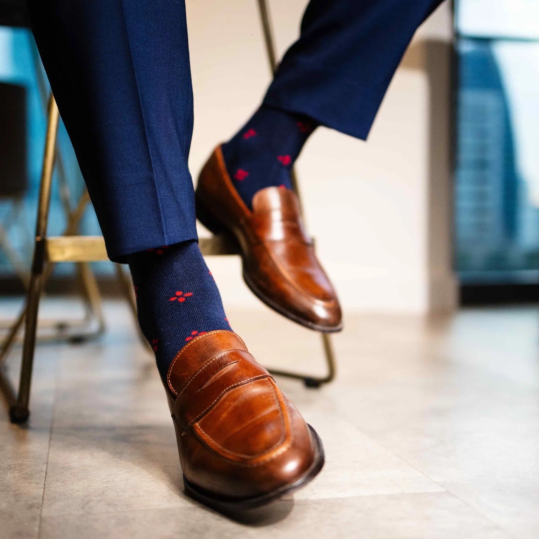 Navy blue men's sock with a cherry red flower pattern