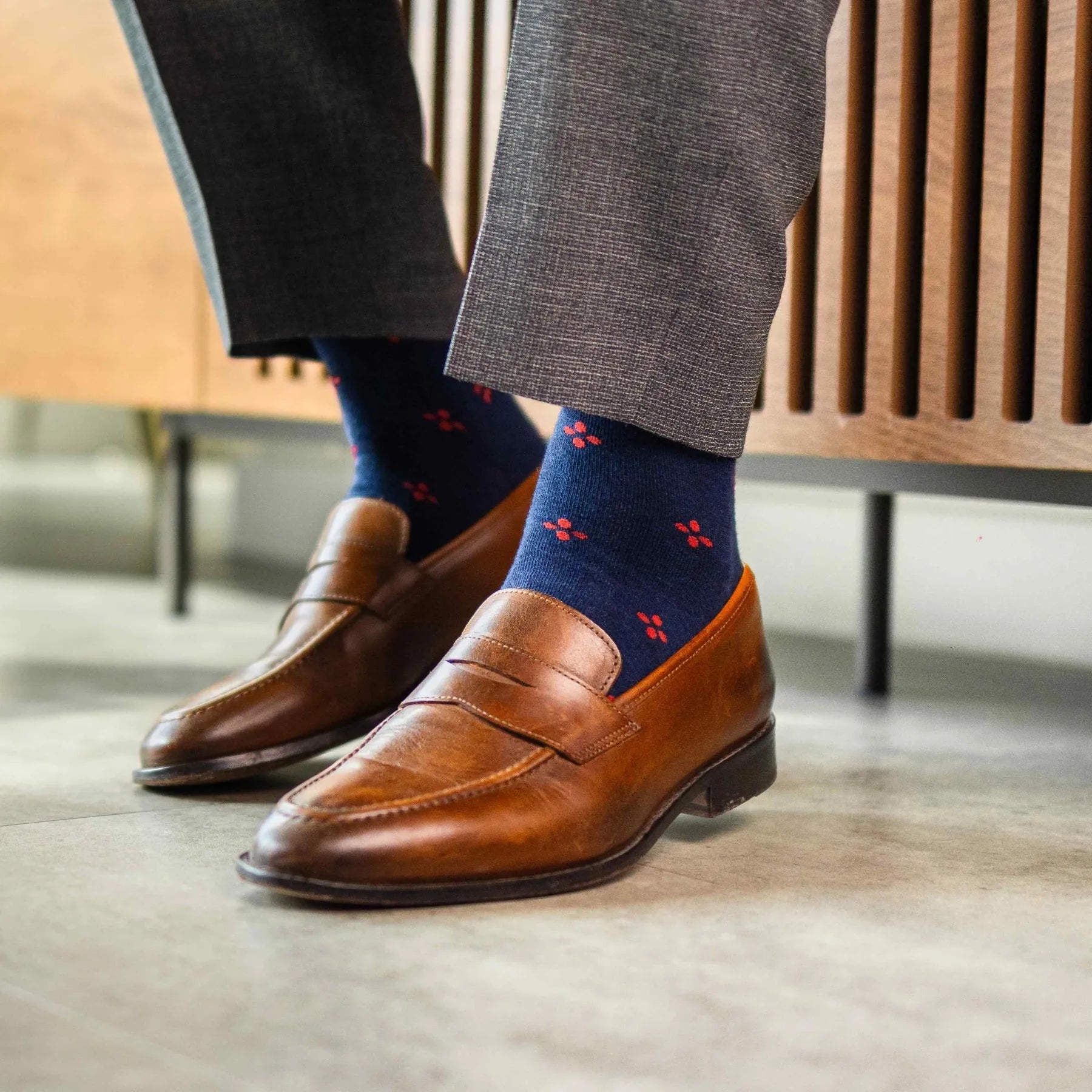 Navy blue men's sock with a cherry red flower pattern