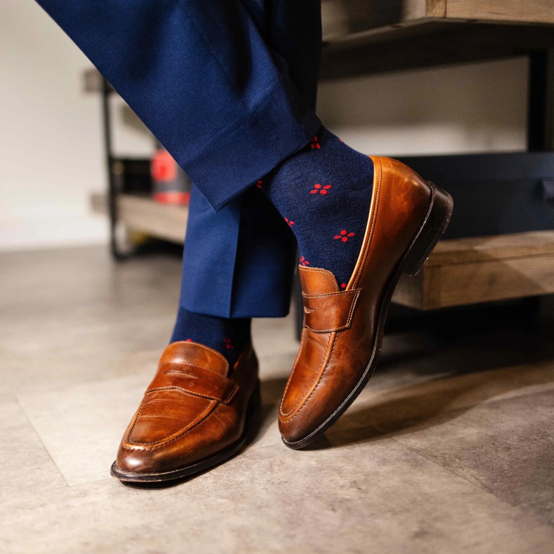 Navy blue men's sock with a cherry red flower pattern