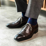 Navy blue men's sock with a garnet red flower pattern