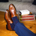 Navy blue men's sock with a garnet red flower pattern