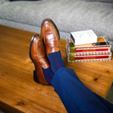 Navy blue men's sock with a garnet red flower pattern