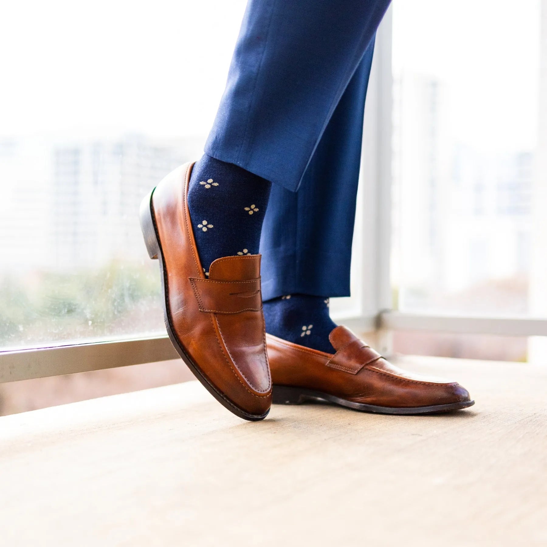 Navy men's dress socks with a gold flower pattern