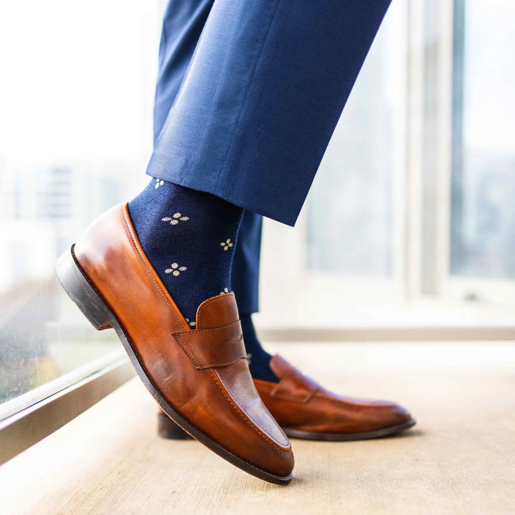Navy men's dress socks with a gold flower pattern