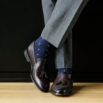 A navy men's dress sock with a white T-sun pattern