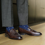 A navy men's dress sock with a white T-sun pattern