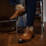 Man wearing oatmeal, solid, mocha ribbed men's dress socks.