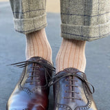 Man wearing oatmeal, solid, mocha ribbed men's dress socks.