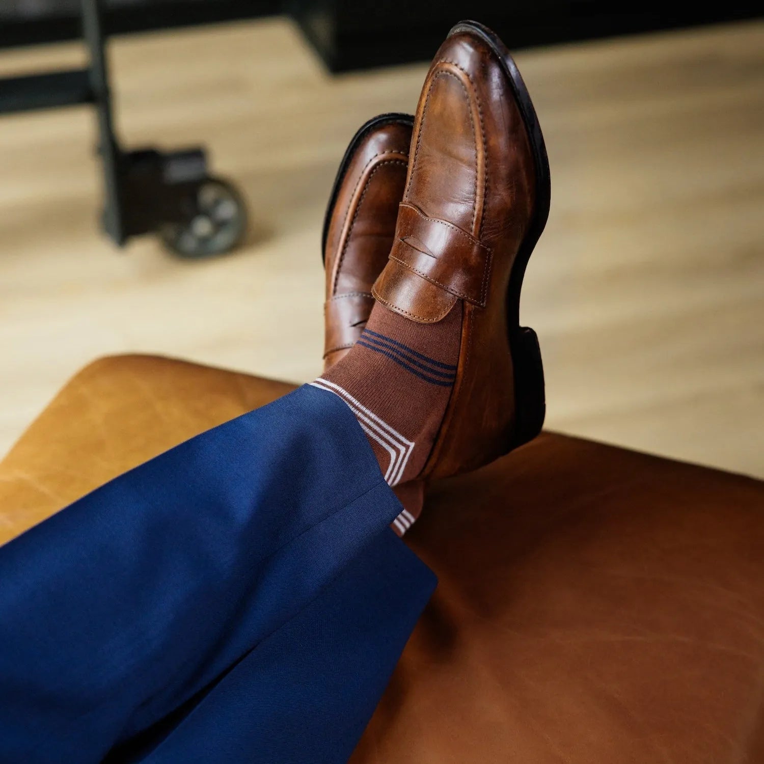 A pecan brown men's dress sock with navy and white stripes 