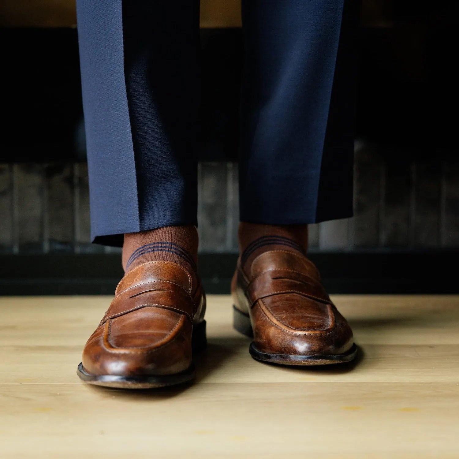 A pecan brown men's dress sock with navy and white stripes 