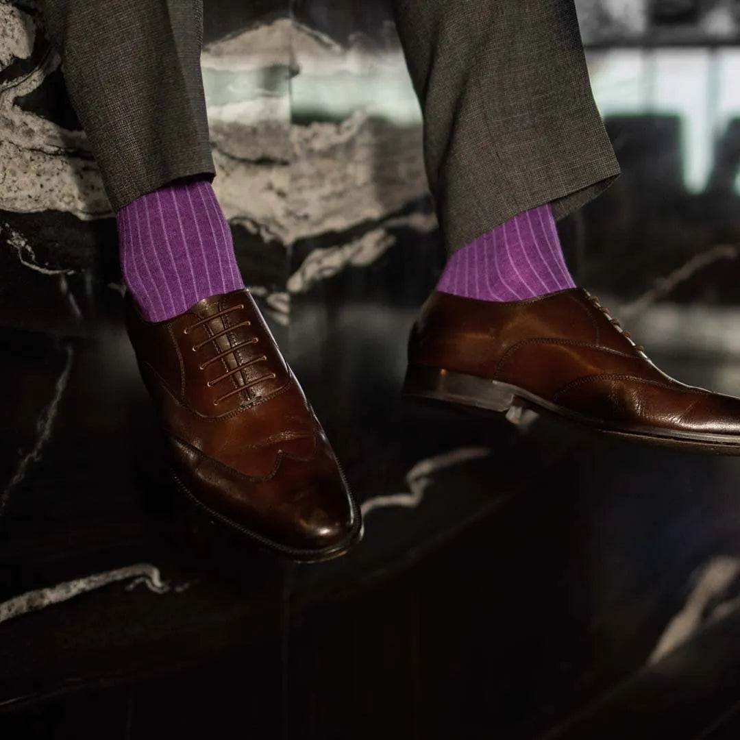 Man wearing plum, solid, violet ribbed men's dress socks with brown shoes.