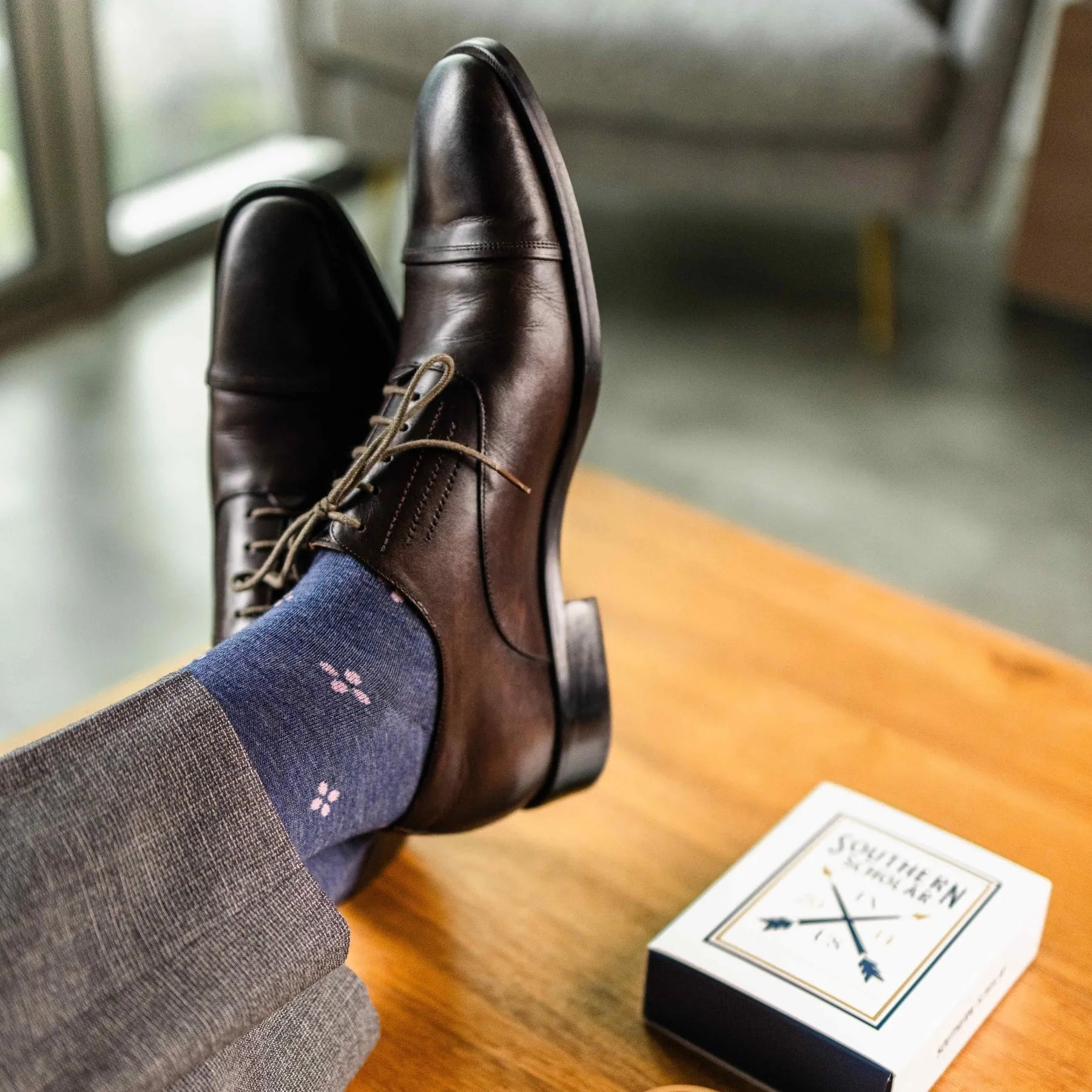 A Prussian Blue men's dress sock with a blush pink flower pattern