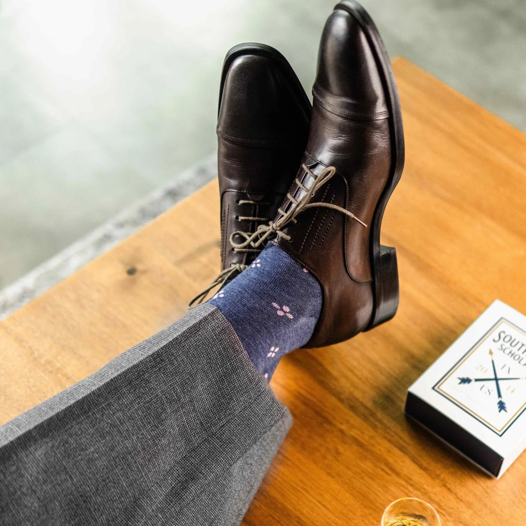 A Prussian Blue men's dress sock with a blush pink flower pattern