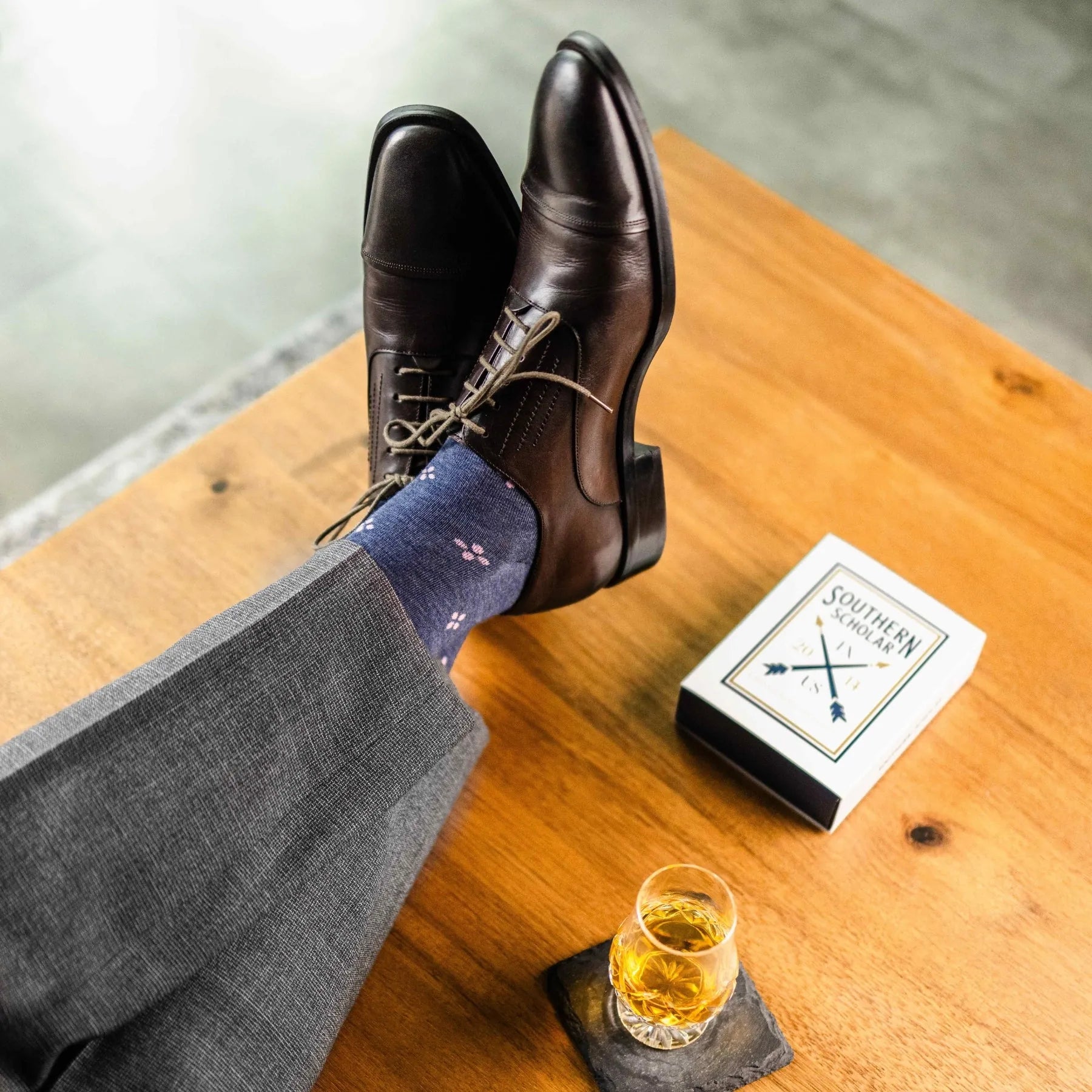 A Prussian Blue men's dress sock with a blush pink flower pattern