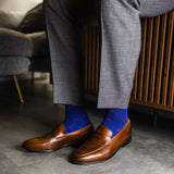 guy in grey slacks wearing royal blue men's dress socks with a red floral flower pattern