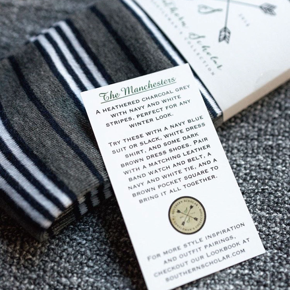 a grey, blue, and white striped men's dress sock with a style card listing out proper outfit suggestions