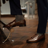 Man wearing solid, gray, and charcoal ribbed men's dress socks.