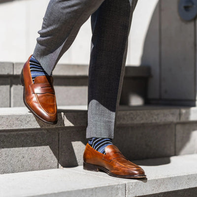 The Alvarados - A Blue, Black and White Striped Sock