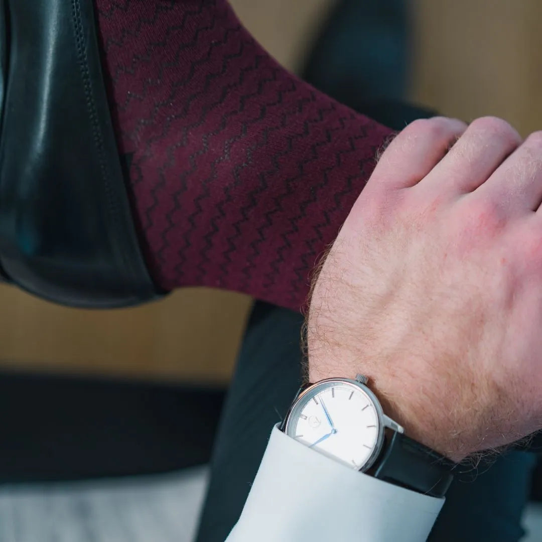 A man wearing red and black striped socks and shoes