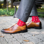 A man wearing Red socks with white hatches