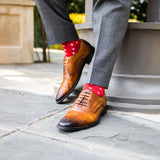 A man wearing Red socks with white hatches with grey slacks