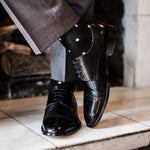 Guy wearing black polka dot socks