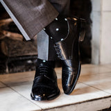 Guy wearing black polka dot socks