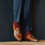 deep red men's dress sock with navy blue polka dots