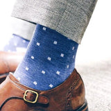 Man wearing heathered blue men's dress sock with ocean blue micro squares with grey slacks and brown shoes