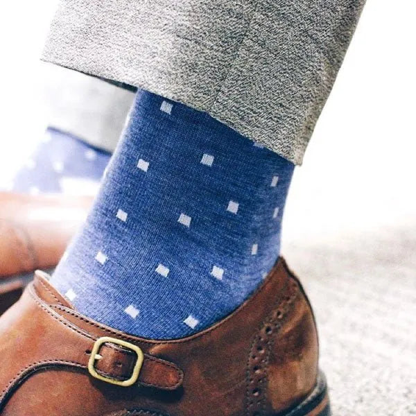 Man wearing heathered blue men's dress sock with ocean blue micro squares with grey slacks and brown shoes