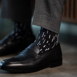 A charcoal men's dress sock with a white and cream speckled pattern