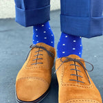 Man wearing sapphire blue, sand and white socks with brown shoes