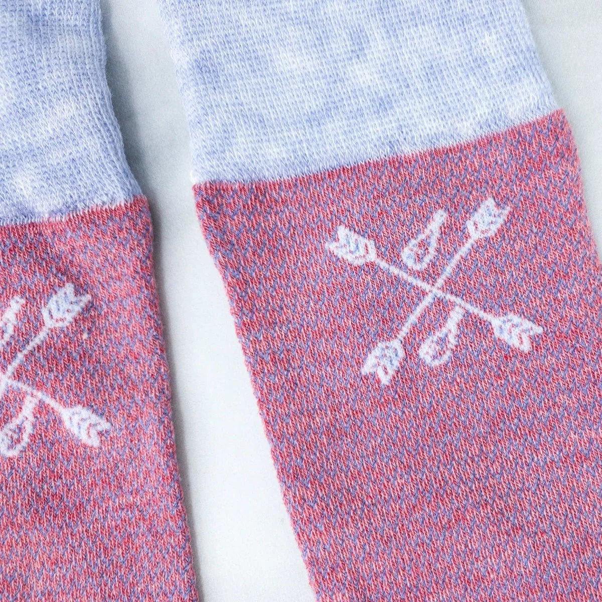 A detail shot of salmon and blue textured and patterned men's socks