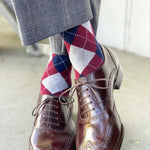 man wearing grey, red, and blue argyle socks