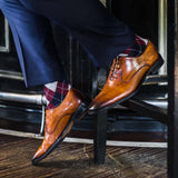 man wearing grey, red, and blue argyle socks