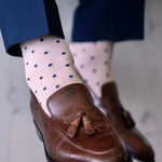 a tan men's dress sock with navy blue squares 