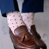 a tan men's dress sock with navy blue squares 