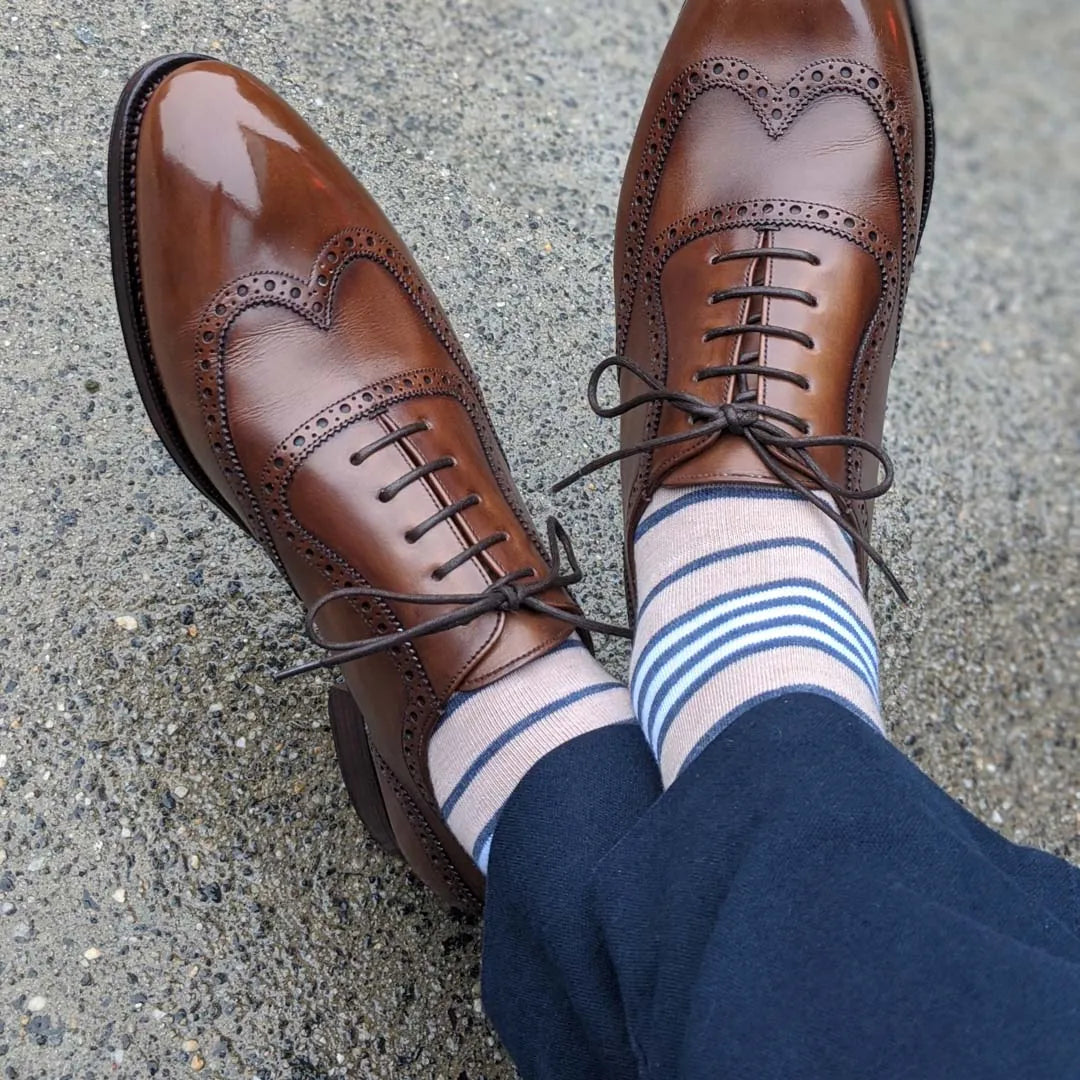 Collection of purple dress socks in solid, striped, and patterned designs.